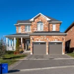 double garage doors on brick house